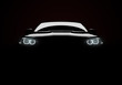 © Cla78 - Front view of a generic and brandless modern car with lights on a black background