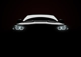 Front view of a generic and brandless modern car with lights on a black background