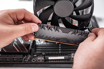 Installing random access memory into PC.