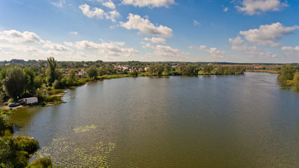 Naklejka na meble Beautiful rural lake surrounded by green trees. Landscape of nature. Aerial view.