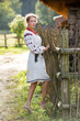 © Flash-Stock - Ukrainian girl in embroidered dress in the village. Portrait of slavonic woman in traditional ukrainian style. Traditional clothes of Ukrainian region.
