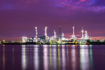 Power plant at dust with reflection over the river Oil and gas industry - Petrochemical factory, Industrial zone and petrochemical plant at sunset