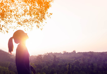 Young beautiful woman relaxing in summer sunrise sky outdoor. People freedom and relaxing in morning fresh air.