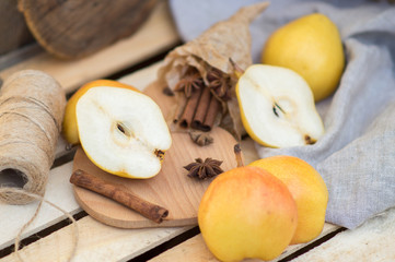 Poster -  juicy ripe pear with cinnamon and thyme on a wooden background