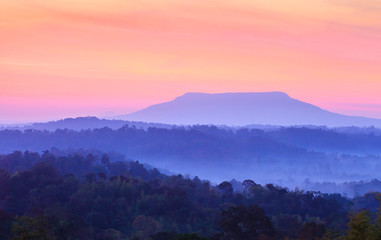 Poster - Dramatic sunrise sky over a blue mountain.