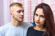 © Вячеслав Чичаев - The concept of family conflict, problems, relationships of young disgruntled husband and wife in a room on the sofa.