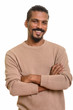 © Ranta Images - Young happy Indian man smiling with arms crossed