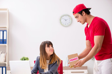 Courier delivering parcel to the office