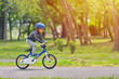 © Daniel CHETRONI - Happy kid boy of 5 years having fun in spring park with a bicycle on beautiful fall day. Active child wearing bike helmet