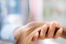 Master Hairdresser Applies Oil To Hair Care For And Restore Growth Of Cuticles Woman.