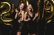 © opolja - Beautiful Women Celebrating New Year. Happy Gorgeous Girls In Stylish Sexy Party Dresses Holding Gold 2019 Balloons, Having Fun At New Year's Eve Party. Holiday Celebration. High Quality Image