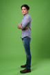© Ranta Images - Young handsome Filipino man against green background