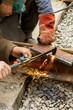 © Aleksandr Lesik - Repair of iron tram line. Installation of railway rails for trams. Laying stone pavers, road paving slabs on street. Repair and reconstruction of urban highways with tram line