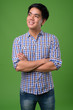 © Ranta Images - Young handsome Filipino man against green background
