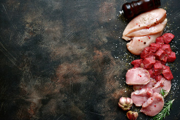 Poster - Assortment of raw fresh white and red meat : chicken breast, beef and pork fillet with spices (garlic, rosemary and dried herbs).Top view with copy space.