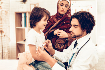 Wall Mural - Arabic Male Doctor Examining Measuring Temperature