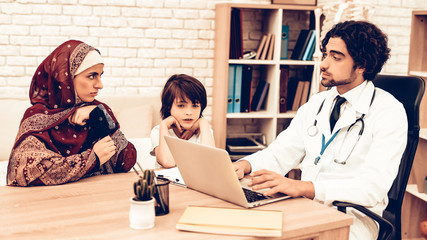 Wall Mural - Arabic Mother with Son at Doctor's Appointment