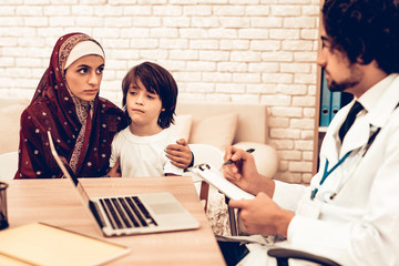 Wall Mural - Arabic Mother with Son at Doctor's Appointment