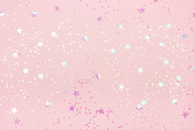 Beautiful Pastel Pink Christmas Background With Star Shaped Confetti. Top View. Copy Space For Your Design.