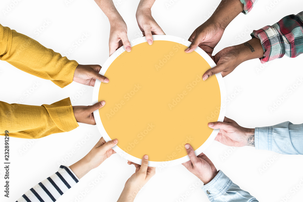 Diverse hands supporting a blank yellow round board - obrazy, fototapety, plakaty 