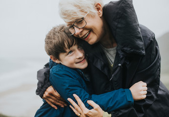 Happy grandmother hugging her grandson