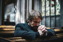 Lonely Christian Man Praying In The Church