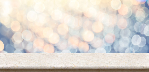 Poster - Empty marble glossy table top with blur sparkling soft pastel blue and orange bokeh abstract background,panoramic banner for display or montage of product,Holiday seasonal concept backdrop.