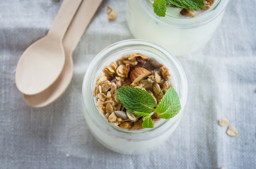 Wall Mural - Homemade granola with greak yogurt in a glass jar. Healthy food concept. Top view, copy space