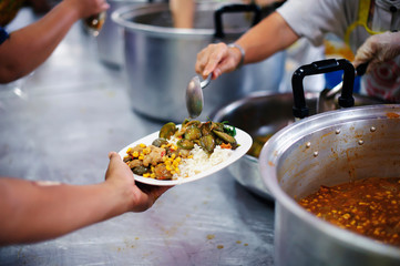 Wall Mural - Volunteers provide food for beggars: Concepts Feeding and help