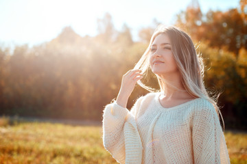 Poster - Pretty girl posing on camera and enjoying sunny autumn day.