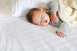 © zilvergolf - Peaceful newborn Asian baby boy sleeping on bed with the blanket.