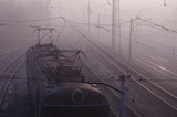 Fototapeta Do akwarium - A Locomotive on the railroad tracks in the morning fog.