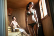 © NDABCREATIVITY - Attractive man and beautiful woman relaxing together in sauna