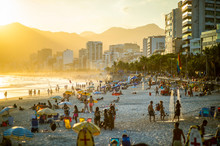 Scenic Golden Sunset View Of Crowds Packing Up To Leave Ipanema Beach In Rio De Janeiro, Brazil
