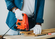 © Rawpixel.com - Man cutting a plank with a jigsaw machine