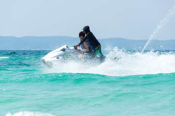 Tourists skiing on water scooter