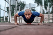 © Friends Stock - African man is doing plank at open air gym near the park