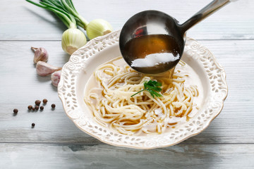 Poster - Broth soup in ceramic plate.