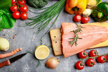 Poster - Raw fishes and vegetables on stone background