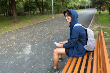 Canvas Print - Smiling young asian man dressed in hoodie