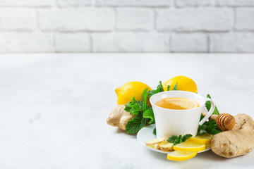 Wall Mural - Ginger tea in a cup for flu cold winter days