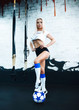 © Maksym - Girl athletic body addition in the room stands with a soccer ball