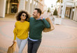 © BGStock72 - Young multiethnic couple with bags in the shopping
