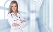 © BillionPhotos.com - Attractive young female doctor with blurred hospital interior on
