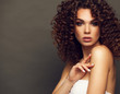 © opolja - Fashion studio portrait of beautiful smiling woman with afro curls hairstyle. Fashion and beauty.