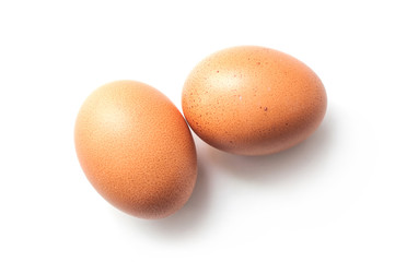 closeup of two organic eggs on white background