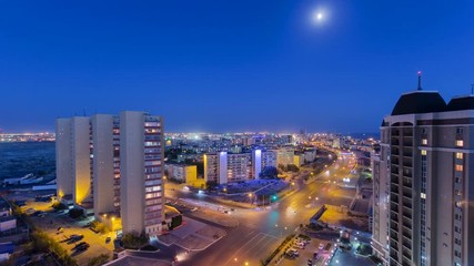 Wall Mural - Aktau city after sunset on the shore of the Caspian Sea day to night timelapse. Kazakhstan.