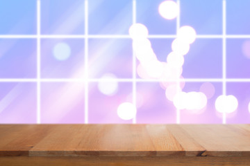 Canvas Print - wooden desk with blurred light bokeh abstract background