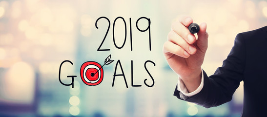 2019 Goals with businessman on blurred abstract background