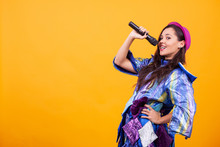 Beautiful Young Woman Wearing Funky Clothes And Singing Microphone. Having Fun